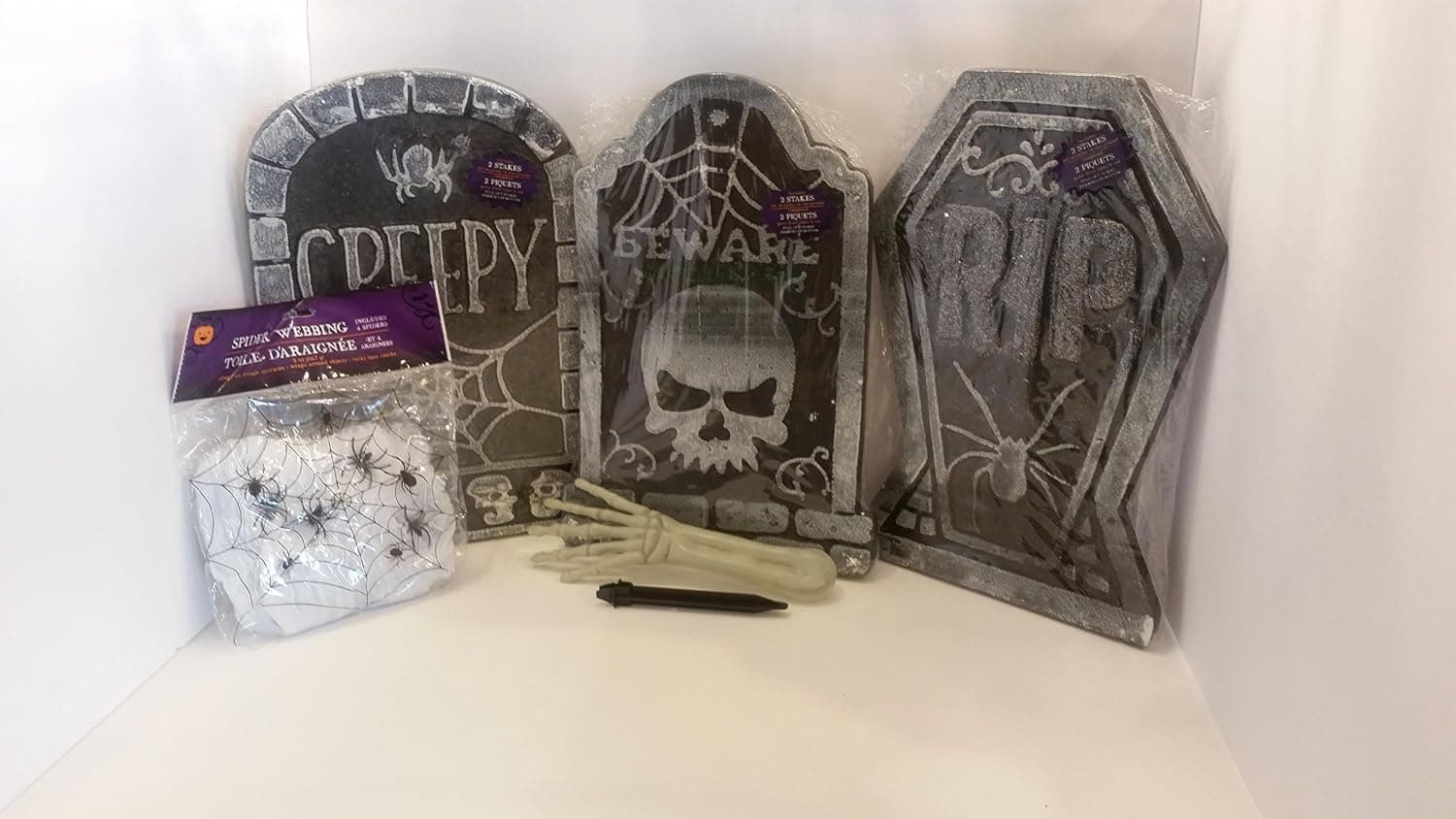 Tombstones (3) with Stakes and 2 oz. Bag of Spider Webbing Kit including 4 spiders and a glow in the dark zombie arm!
