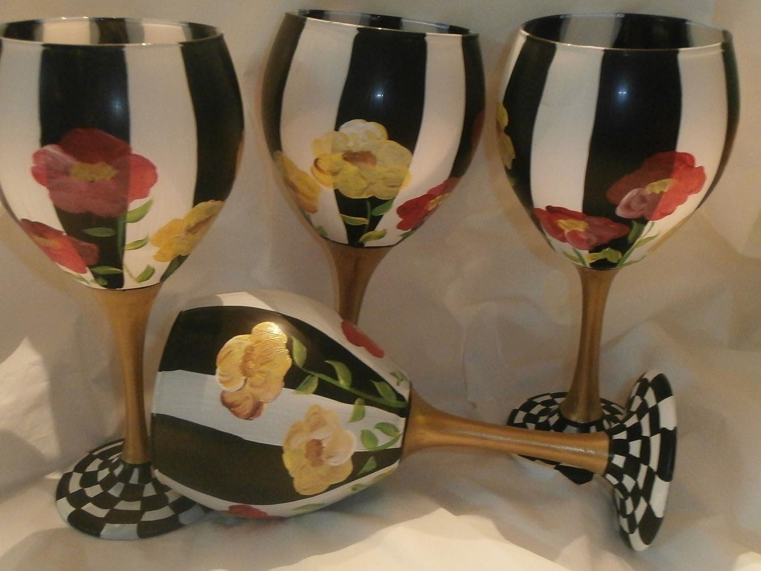 Hand painted Red and Yellow poppies. Painted with black and white stripes. Gold Stem and checked base. This set is so pretty. Great gift. Great set. usa. Set of 4 goblets. 20 ounces each.